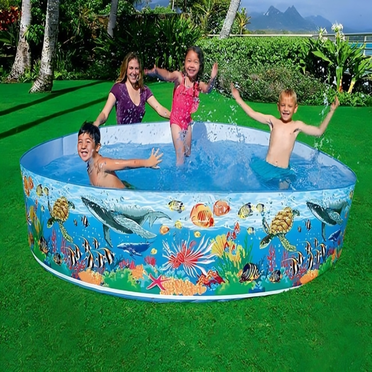 Children playing in a colorful inflatable pool with an underwater design on a green lawn.