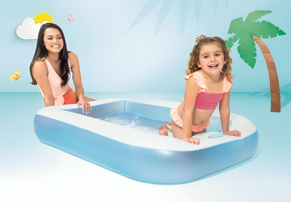 Woman and child playing in an inflatable pool with palm tree and cloud decorations.