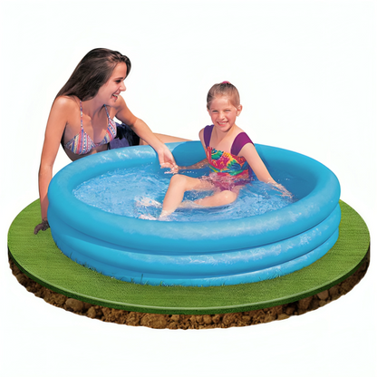 Two children playing in a blue inflatable pool on a grassy area.