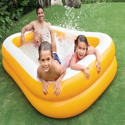 Family playing in a heart-shaped inflatable pool on a grassy area