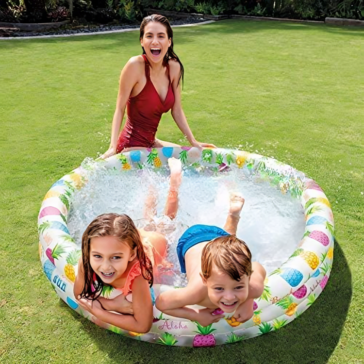 Children playing in a colorful inflatable pool on grass