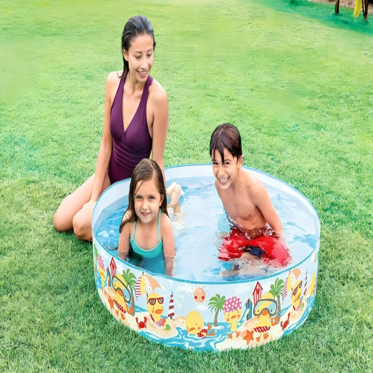 Family playing in a colorful inflatable pool on grass